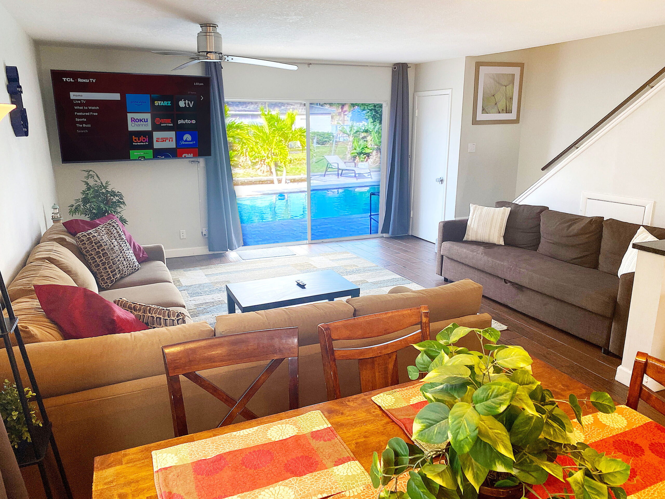 Living room with sectional sofa and pool view at Tarpon Harbor 1 vacation rental