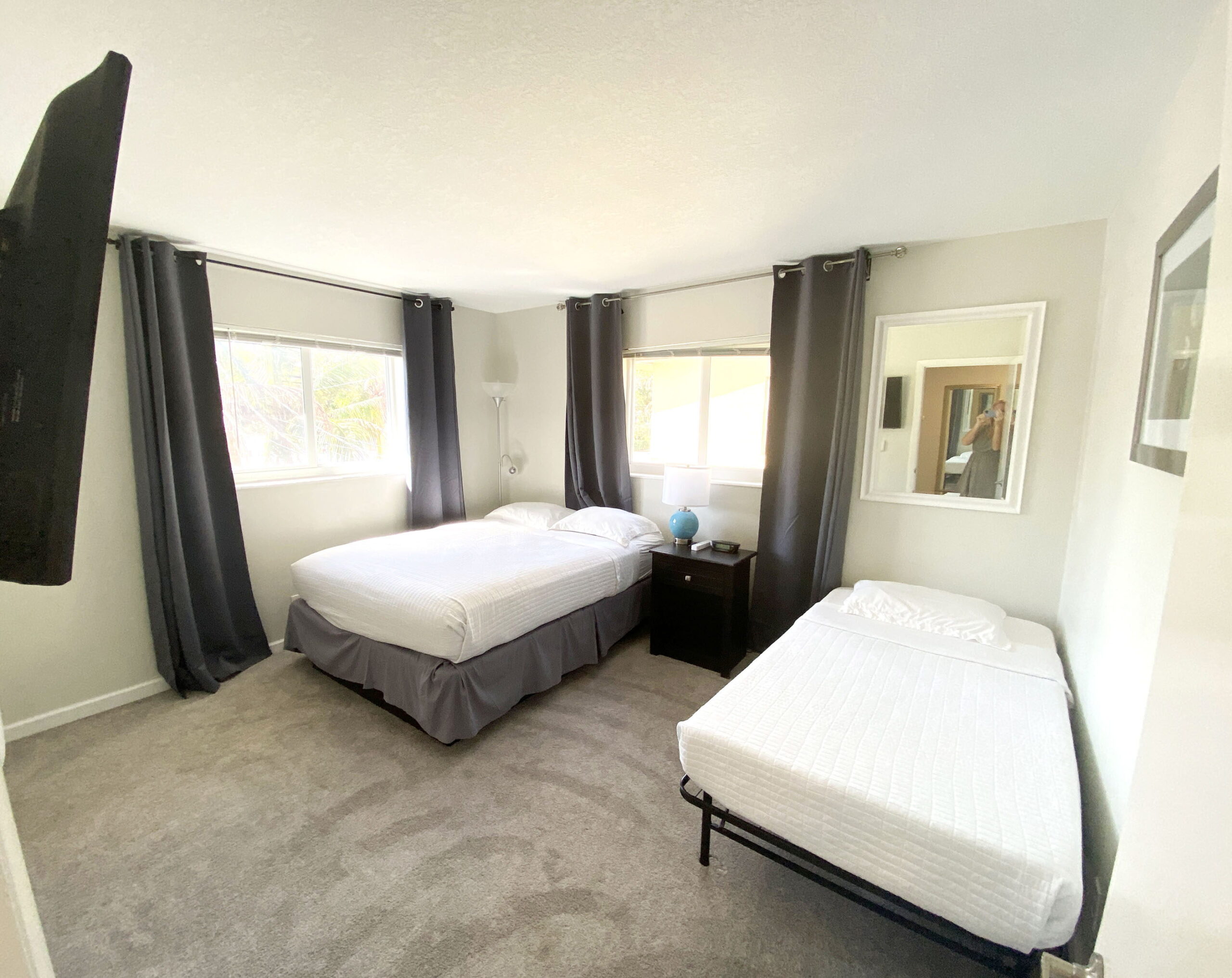 Guest bedroom with queen bed and twin bed at Tarpon Harbor 1 vacation rental